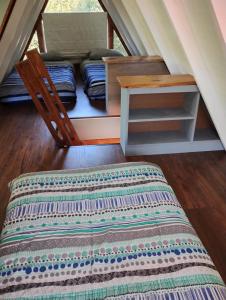 a bedroom with a bed and a table in a room at Mini cabaña in Pucón +1 photo