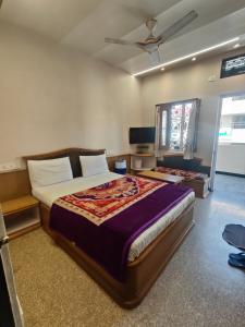 a bedroom with a bed and a ceiling fan at Hotel Priyanka - 750 metres from nakki lake Near Bus Stand in Mount Ābu