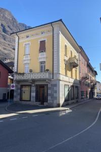 a yellow building on the side of a street at Apartment AMARCORD Loft by Interhome in Biasca
