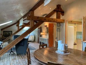 a living room with a wooden table in a room at Apartment AMARCORD Loft by Interhome in Biasca