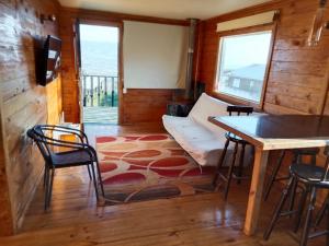 a living room with a couch and a table at Cabaña tree in Boca Pupuya