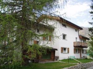 a large white house with a tree in front of it at Apartment Studio Chesa Marias by Interhome in Sils Maria