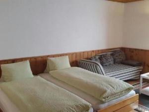 a room with two beds and a chair in it at Apartment Studio Chesa Marias by Interhome in Sils Maria +16 photos