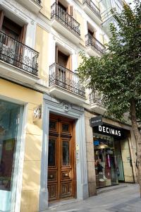 a building with a wooden door on a street at Apartamentos Fuencarral II in Madrid