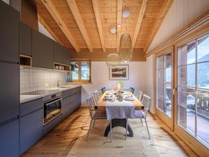 a dining room with a table and chairs in a kitchen at Apartment Blue Alpine Lodge by Interhome in Rueras