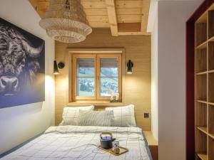 a bedroom with a bed and a picture of a cow at Apartment Blue Alpine Lodge by Interhome in Rueras +38 photos