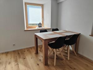 a table and chairs in a room with a window at Apartment Günter by Interhome in Sagogn