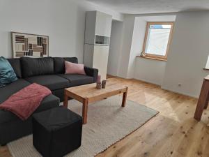 a living room with a couch and a coffee table at Apartment Günter by Interhome in Sagogn