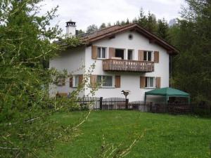 a white house with a balcony and a yard at Apartment 4 Bettwohnung by Interhome in Sils Maria