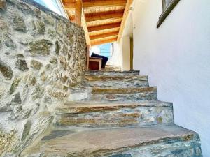 a stone staircase in a building with a stone wall at Apartment casa M by Interhome in Vella