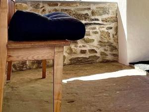 a blue pillow sitting on top of a wooden bench at Apartment casa M by Interhome in Vella +42 photos