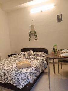 a bedroom with a bed and a table with a table at Casa Iris - One Bedroom in a 3BHK Apartment in Hyderabad