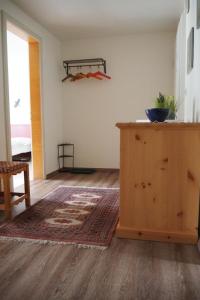 a living room with a wooden cabinet and a rug at Apartment Chasura by Interhome in Pontresina +15 photos