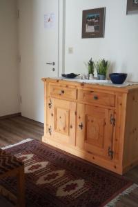 a wooden cabinet with two bowls on top of it at Apartment Chasura by Interhome in Pontresina