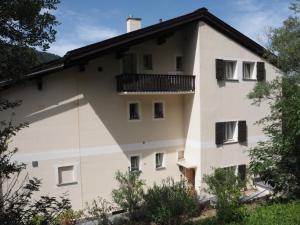 a large white building with a balcony at Apartment Chasura by Interhome in Pontresina