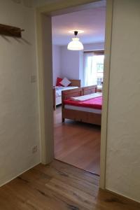 a room with a bedroom with a bed and a window at Apartment Chasa Jaro by Interhome in Santa Maria Val Müstair