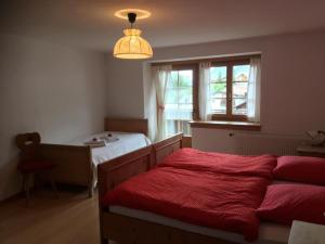a bedroom with two beds and a window and a lamp at Apartment Chasa Jaro by Interhome in Santa Maria Val Müstair