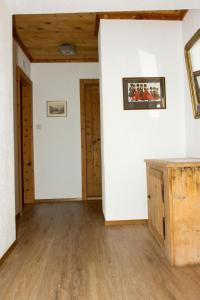 an empty room with white walls and wooden floors at Apartment Chesa Müller by Interhome in Zuoz