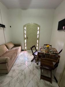 a living room with a couch and a table at Casa aconchegante em Barra dos Coqueiros in Barra dos Coqueiros