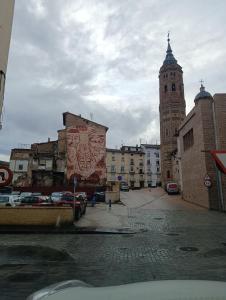 a building with a clock tower in a city at Las Torres 2 in Calatayud