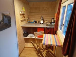a small kitchen with a table and a chair at Holiday Home Tiny Hause by Interhome in St. Gallen