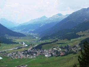 a town in the middle of a valley with mountains at Apartment Culaischem 2 by Interhome in Zuoz