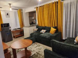 a living room with a couch and a table at Ansan Comfort in Gatunga