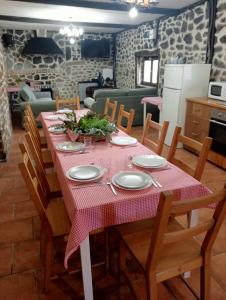 a dining room with a table with a pink table cloth at Caserío Areitz Soroa in Arce