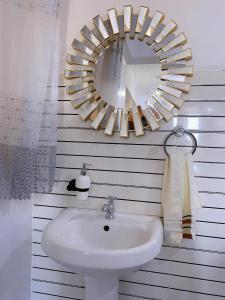 a bathroom with a sink and a mirror on the wall at Njiwa suites 1034 in Mombasa