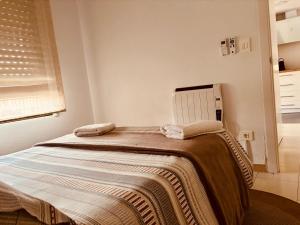 a bedroom with a bed with a blanket on it at Costa Flow Apto Benicasim in Benicàssim +24 photos