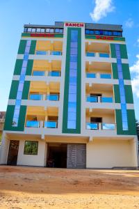 a tall building with blue and green at Khalisee homes studio apartment 4 in Voi