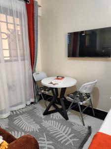 a small room with a table and two chairs at Khalisee homes studio apartment 4 in Voi
