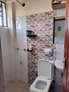 a bathroom with a toilet and a sink at Khalisee homes studio apartment 4 in Voi +17 photos