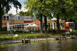 a building next to a body of water with a building at DämeritzSeehotel in Berlin