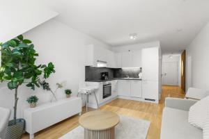 a white living room with a white couch and a table at U1 Metro Nearby - 1-BR - fast Wi-Fi in Vienna