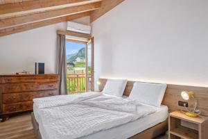 a bedroom with a bed and a large window at Agritur La Crucola in Flavon