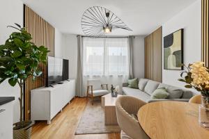 a living room with a couch and a tv at U1 Metro Nearby - 1-BR - fast Wi-Fi in Vienna +13 photos