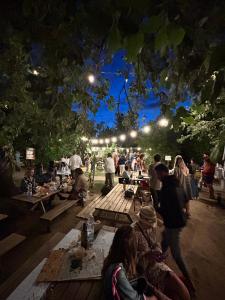 a group of people sitting at picnic tables at night at Agriturismo Amarasca in Gagno