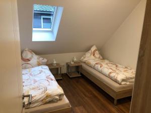 a small room with two beds and a window at Apartment Heidestrauch by Interhome in Thülsfeld