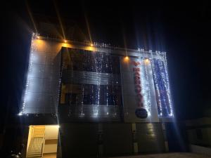 a building with lights on the side of it at night at MADAVATH RESIDENCY in Kenichira