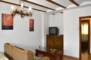a living room with a couch and a tv at Casas rurales la Codorniz in Almaciles