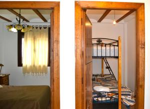 a bedroom with a bunk bed and a room with a bunk bed at Casas rurales la Codorniz in Almaciles