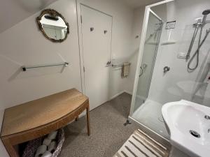 a bathroom with a shower and a sink at Pet Friendly Country Cottage in Dunedin +22 photos