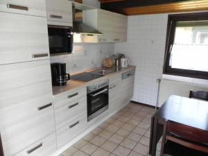 a kitchen with a sink and a stove top oven at Holiday Home by Interhome in Großwürden