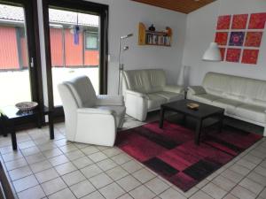a living room with two white couches and a table at Holiday Home by Interhome in Großwürden
