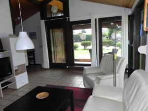 a living room with a couch and a table at Holiday Home by Interhome in Großwürden +19 photos
