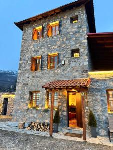 a large stone building with a door in front of it at ByDoukas Mountain Resort in Palaios Agios Athanasios