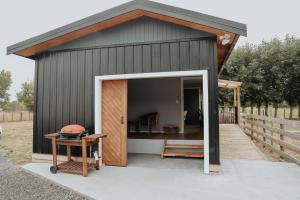 a small shed with a door open and a table at Kay Bell in Masterton