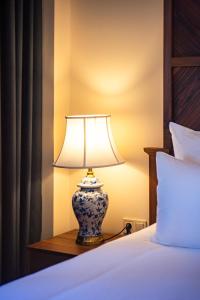 a lamp sitting on a table next to a bed at Agarani Estate in Telavi +60 photos