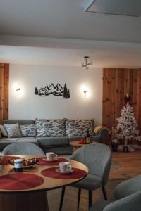 a living room with a couch and a christmas tree at AHAVA Spa Residence in Žabljak